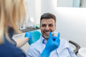 Dentist showing adult male an Invisalign tray